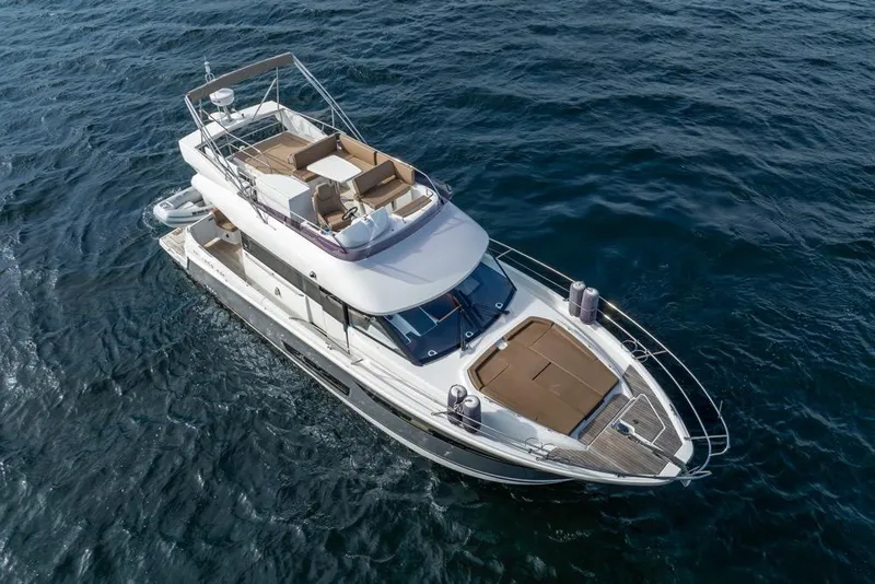 Slide: The Image of 2016 Jeanneau Velasco 43F yacht cruising on open water, aerial view. - 55
