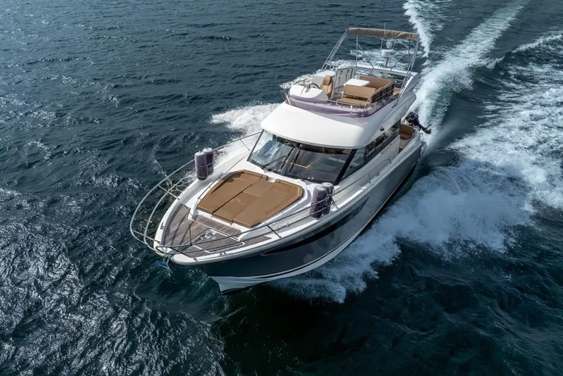 Slide: The Image of 2016 Jeanneau Velasco 43F yacht cruising on open water, aerial view. - 6
