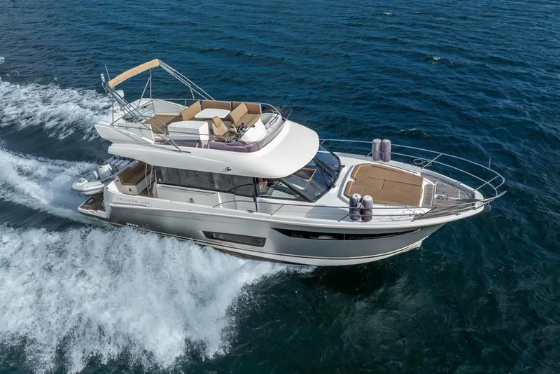 Slide: The Image of 2016 Jeanneau Velasco 43F yacht cruising on open water, showcasing sleek design and luxury. - 60