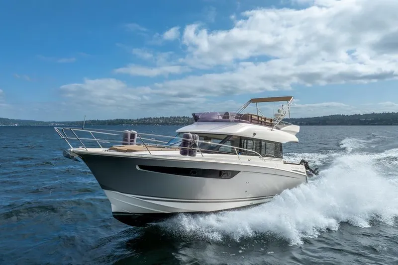 Slide: The Image of 2016 Jeanneau Velasco 43F yacht cruising on open water under a clear blue sky. - 61