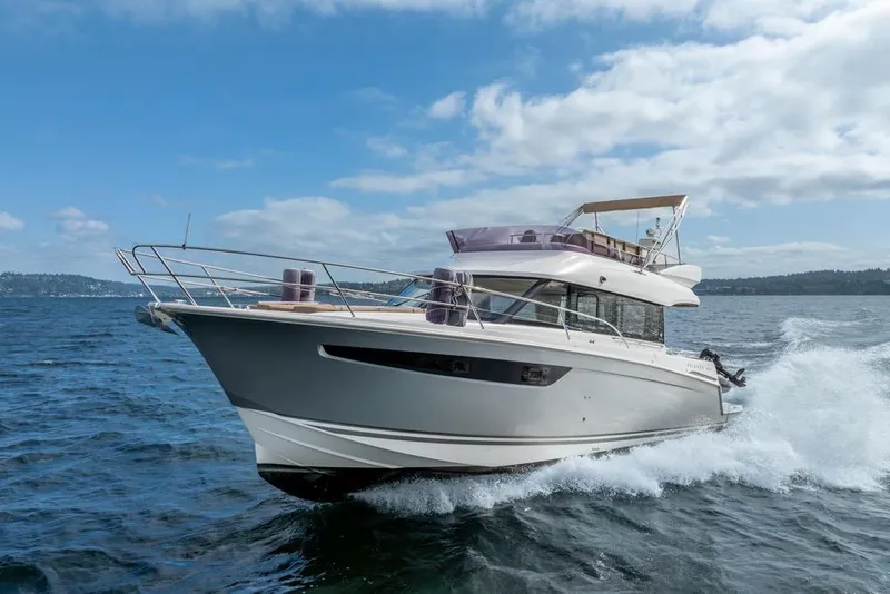Slide: The Image of 2016 Jeanneau Velasco 43F yacht cruising on open water under a clear sky. - 62