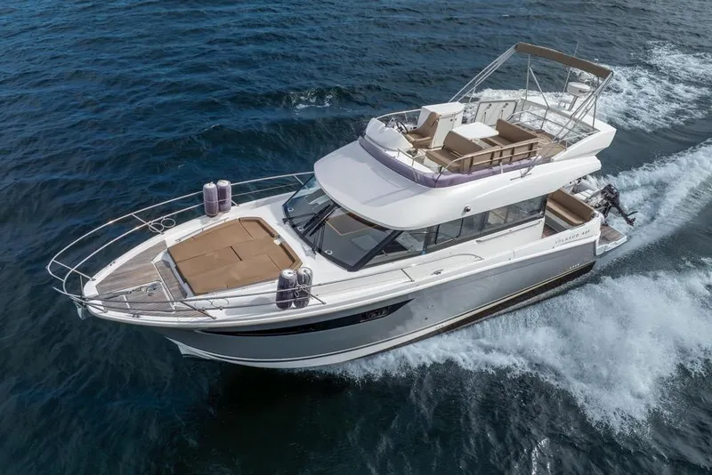 Slide: The Image of 2016 Jeanneau Velasco 43F yacht cruising on open water, aerial view. - 63