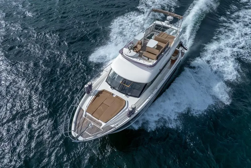 Slide: The Image of 2016 Jeanneau Velasco 43F yacht cruising on open water, aerial view. - 64
