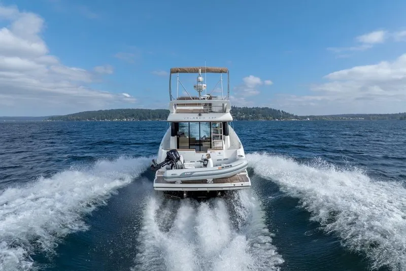 Slide: The Image of 2016 Jeanneau Velasco 43F cruising on open water, leaving a wake behind. - 7