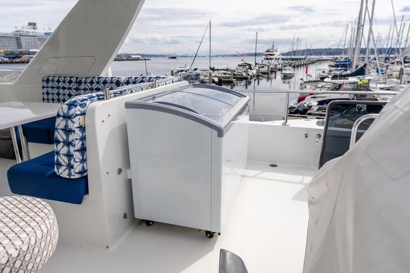 Slide: The Image of 2013 Ocean Alexander 72 Pilothouse yacht deck with seating and marina view. - 12