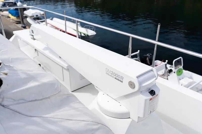 Slide: The Image of Crane on 2013 Ocean Alexander 72 Pilothouse yacht, docked with boats in background. - 13