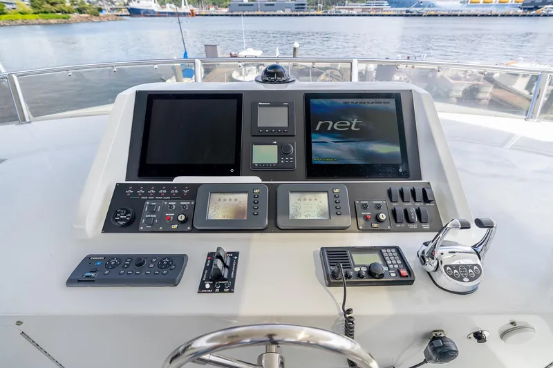 Slide: The Image of Pilothouse controls of 2013 Ocean Alexander 72, featuring navigation screens and communication equipment. - 19