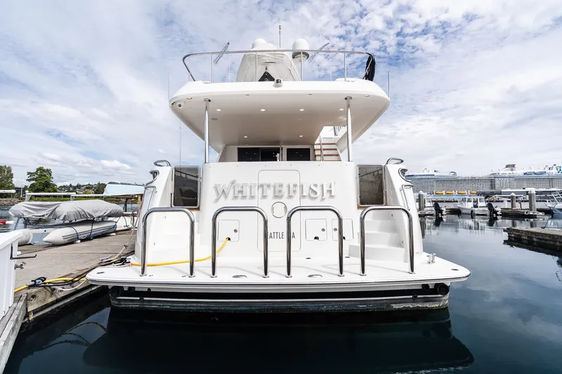 Slide: The Image of 2013 Ocean Alexander 72 Pilothouse yacht docked at marina under cloudy sky. - 2