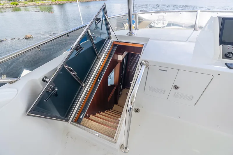 Slide: The Image of Stairway entrance on 2013 Ocean Alexander 72 Pilothouse yacht, featuring sleek design and water view. - 20