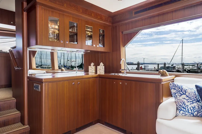 Slide: The Image of Luxurious 2013 Ocean Alexander 72 Pilothouse yacht interior with elegant wood cabinetry and marina view. - 25