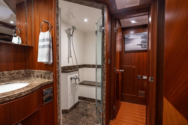 Slide: The Image of Luxurious bathroom in 2013 Ocean Alexander 72 Pilothouse yacht with marble accents and wood paneling. - 33