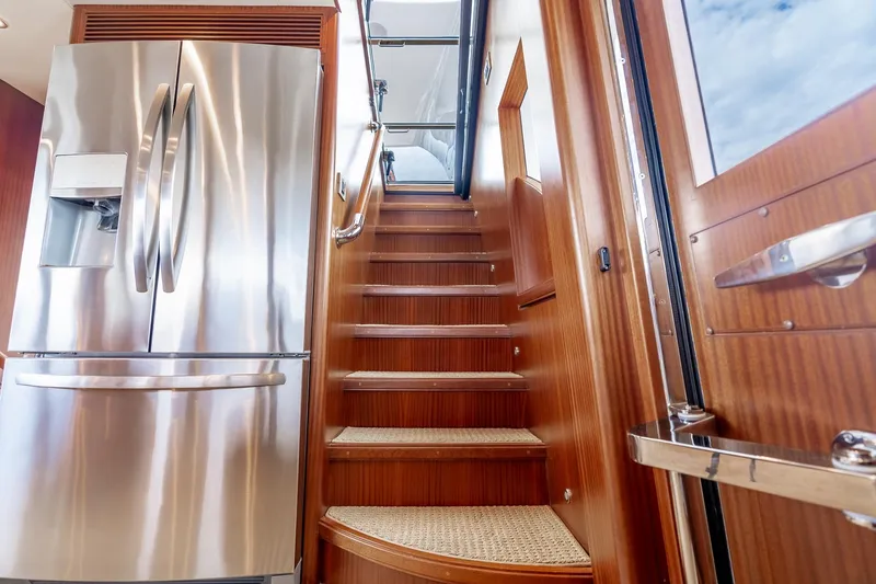 Slide: The Image of Luxurious interior of 2013 Ocean Alexander 72 Pilothouse with stainless steel fridge and wooden stairs. - 38