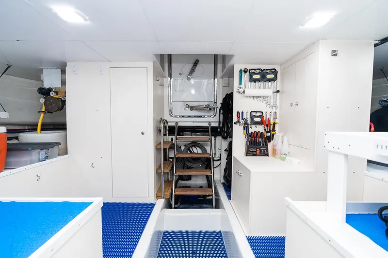 Slide: The Image of Engine room of 2013 Ocean Alexander 72 Pilothouse with organized tools and equipment. - 57