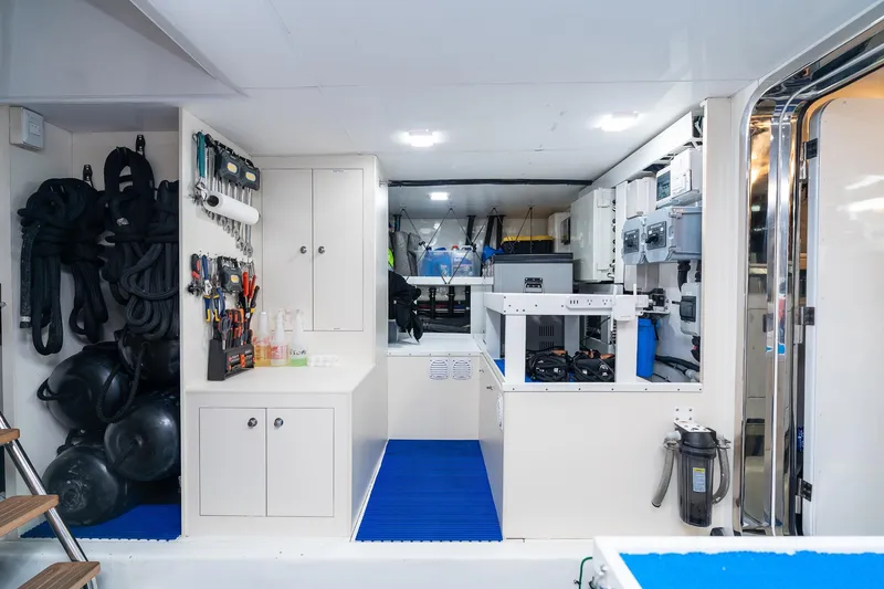 Slide: The Image of Engine room of 2013 Ocean Alexander 72 Pilothouse yacht, featuring organized tools and equipment. - 58