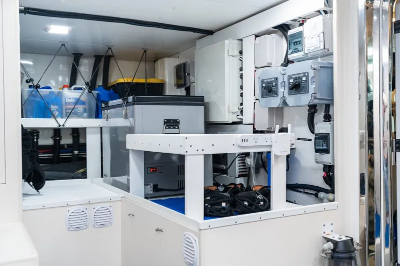 Slide: The Image of Engine room of 2013 Ocean Alexander 72 Pilothouse yacht, featuring equipment and storage. - 59