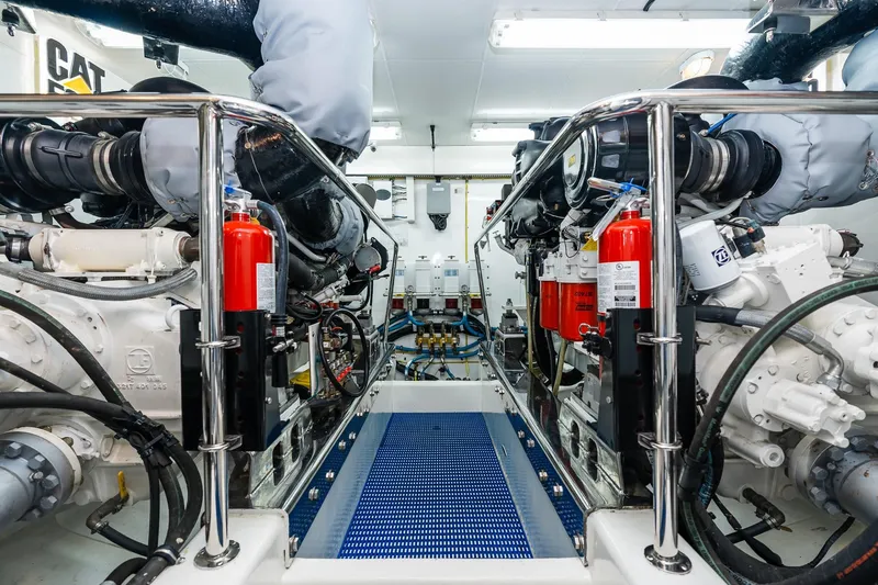 Slide: The Image of Engine room of 2013 Ocean Alexander 72 Pilothouse yacht, featuring dual engines and safety equipment. - 62