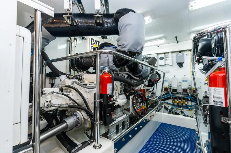Slide: The Image of Engine room of 2013 Ocean Alexander 72 Pilothouse yacht, featuring advanced machinery and safety equipment. - 65