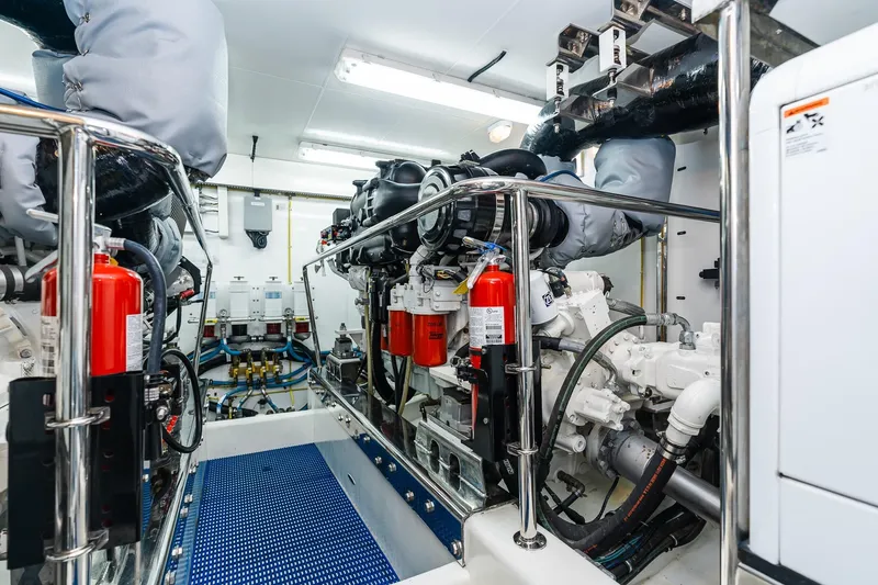 Slide: The Image of Engine room of 2013 Ocean Alexander 72 Pilothouse yacht, featuring advanced machinery and safety equipment. - 66