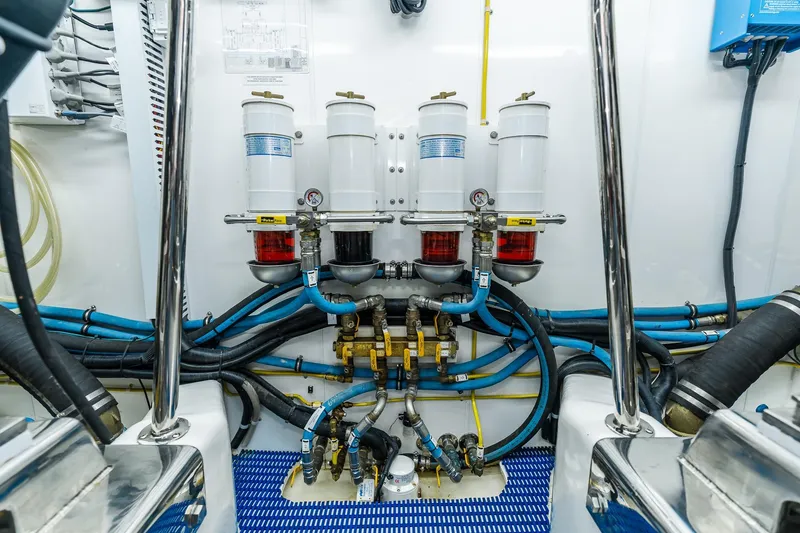 Slide: The Image of Engine room of 2013 Ocean Alexander 72 Pilothouse with fuel filtration system and hoses. - 67