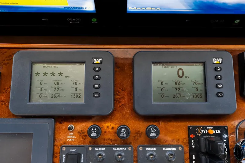 Slide: The Image of Control panel of a 2013 Ocean Alexander 72 Pilothouse yacht, featuring CAT engine displays. - 69