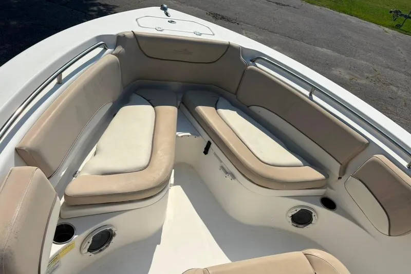 Slide: The Image of 2016 NauticStar 2102 Legacy boat interior with beige cushioned seating. - 11