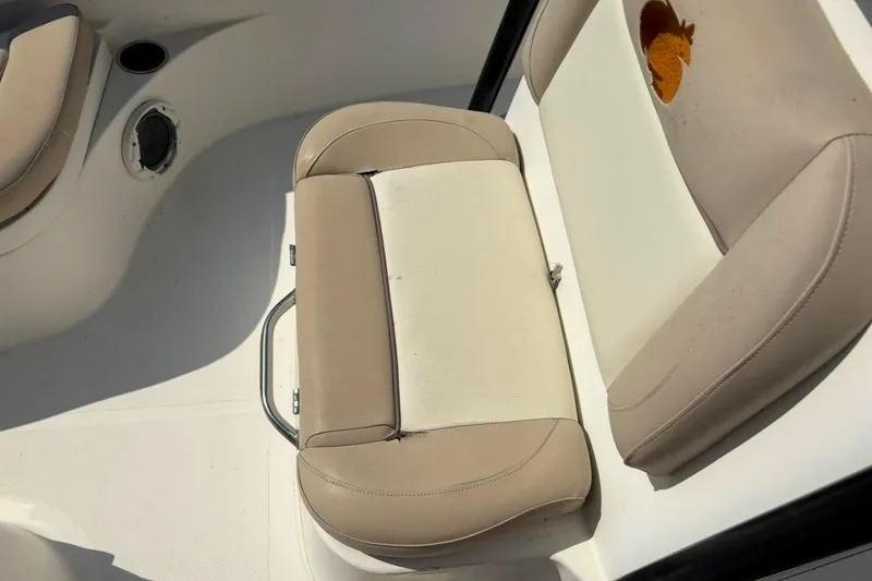 Slide: The Image of 2016 NauticStar 2102 Legacy boat interior with beige and white seating. - 12