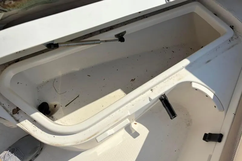 Slide: The Image of Open storage compartment on a 2016 NauticStar 2102 Legacy boat. - 14