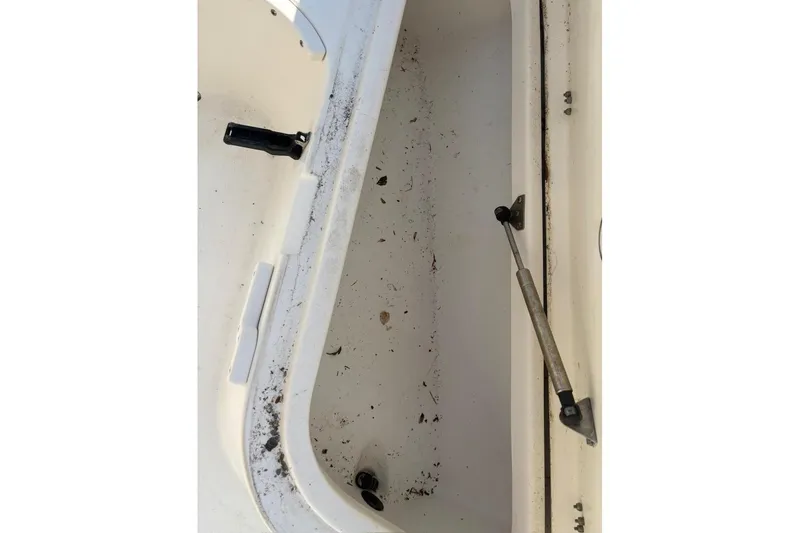 Slide: The Image of Open storage compartment of 2016 NauticStar 2102 Legacy boat, showing interior details. - 15