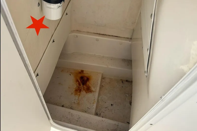 Slide: The Image of 2016 NauticStar 2102 Legacy boat interior with rust stain on the floor. - 16