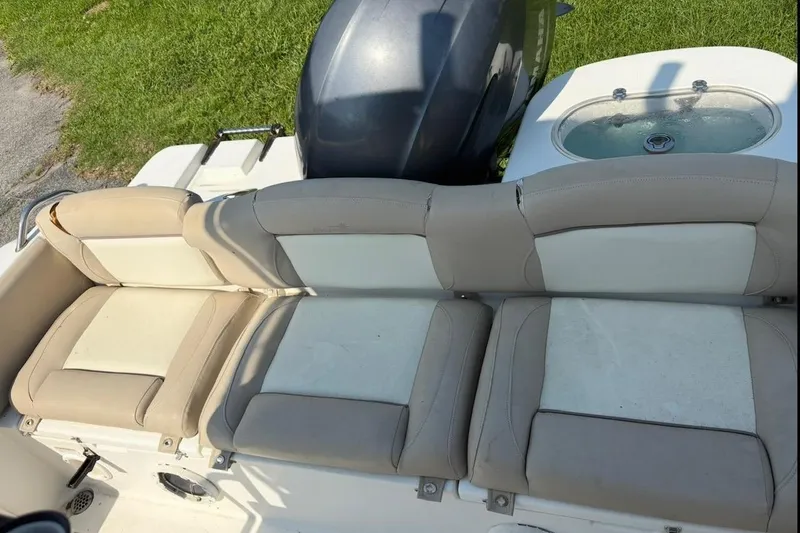 Slide: The Image of 2016 NauticStar 2102 Legacy boat seats and engine, with livewell in background. - 17