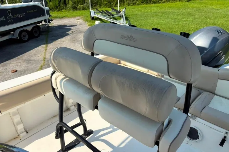 Slide: The Image of 2016 NauticStar 2102 Legacy boat seating with cushioned backrest and outdoor setting. - 18