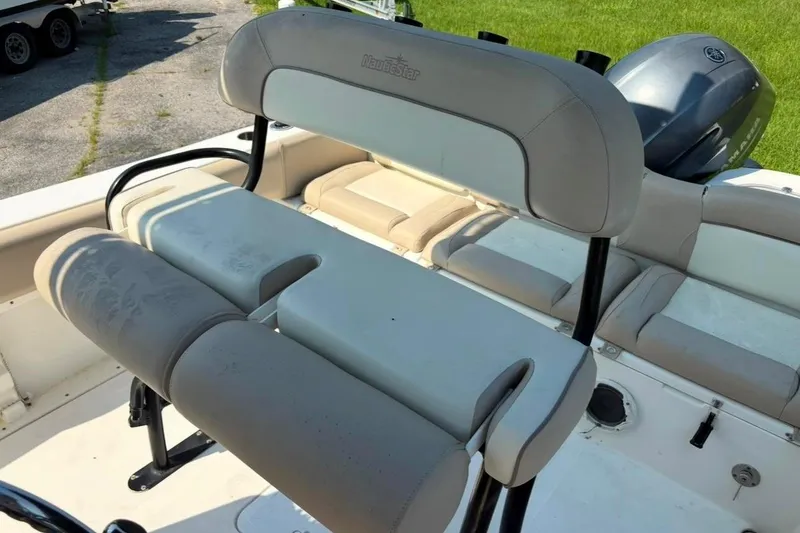 Slide: The Image of 2016 NauticStar 2102 Legacy boat interior with cushioned seating and motor. - 19
