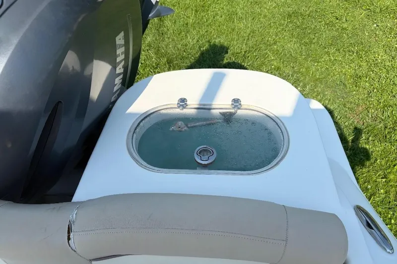 Slide: The Image of 2016 NauticStar 2102 Legacy boat with Yamaha engine, featuring a livewell on deck. - 3