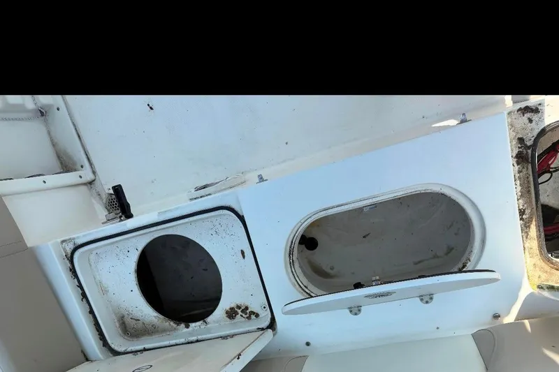 Slide: The Image of 2016 NauticStar 2102 Legacy boat storage compartments, open and showing interior details. - 7