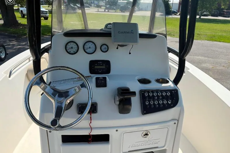 Slide: The Image of 2016 NauticStar 2102 Legacy boat dashboard with Garmin GPS and steering wheel. - 8