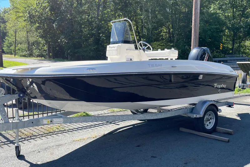 Slide: The Image of 2025 Bayliner Trophy T18 boat on trailer, parked outdoors. - 0