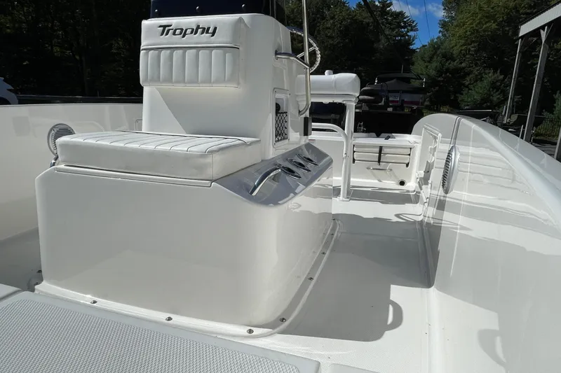 Slide: The Image of 2025 Bayliner Trophy T18 boat interior with white seating and console. - 3