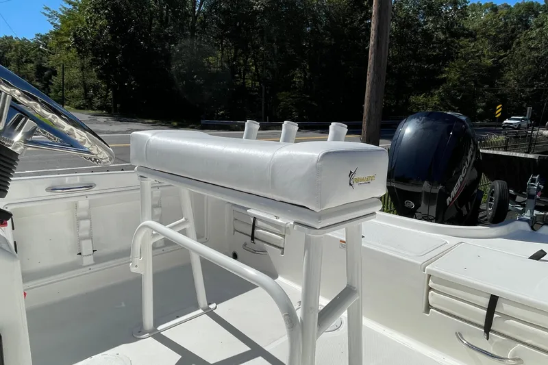 Slide: The Image of 2025 Bayliner Trophy T18 boat interior with white seating and Mercury outboard motor. - 4