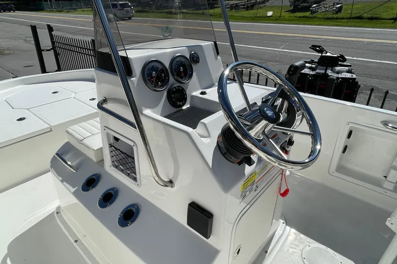 Slide: The Image of 2025 Bayliner Trophy T18 boat console with steering wheel and gauges. - 5