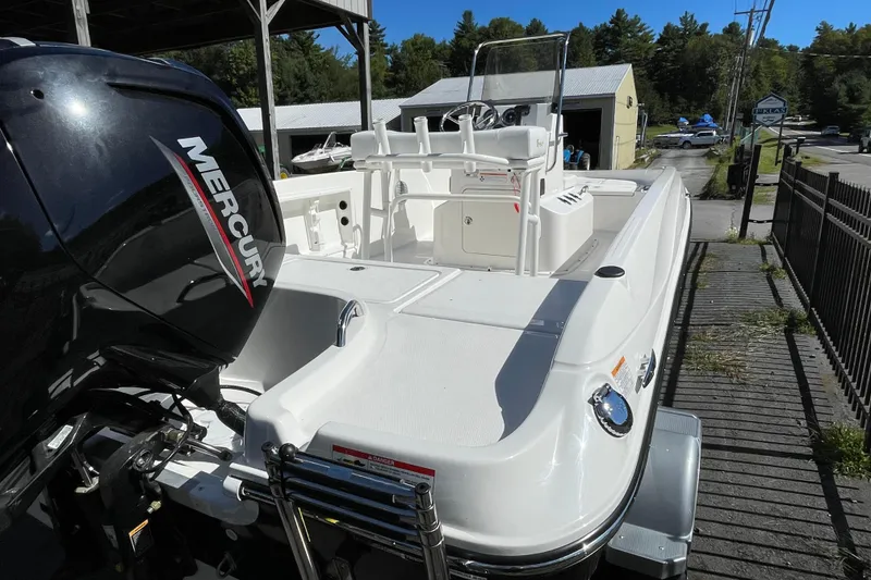 Slide: The Image of 2025 Bayliner Trophy T18 boat with Mercury engine, docked outdoors. - 6