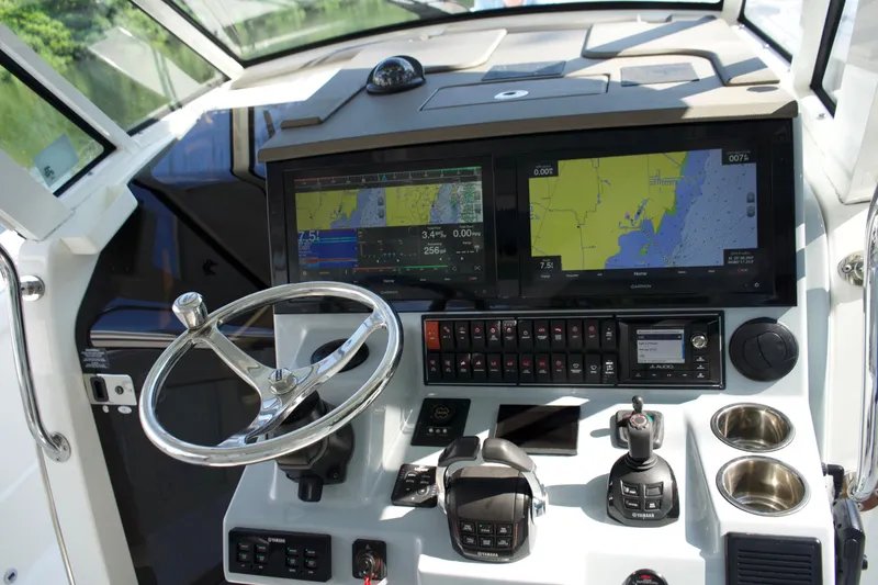 Slide: The Image of 2021 Pursuit S 378 Sport boat dashboard with navigation screens and controls. - 18