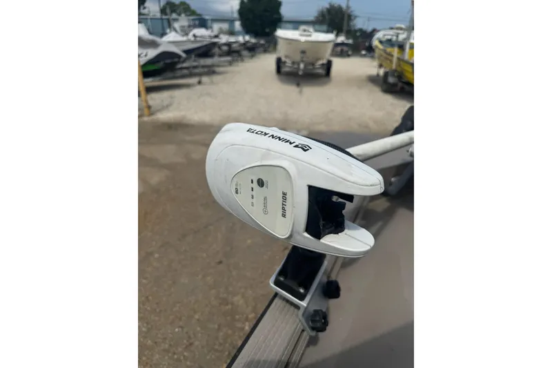 Slide: The Image of Minn Kota Riptide motor on 2020 Excel 203 Bay Pro boat, parked in marina. - 12
