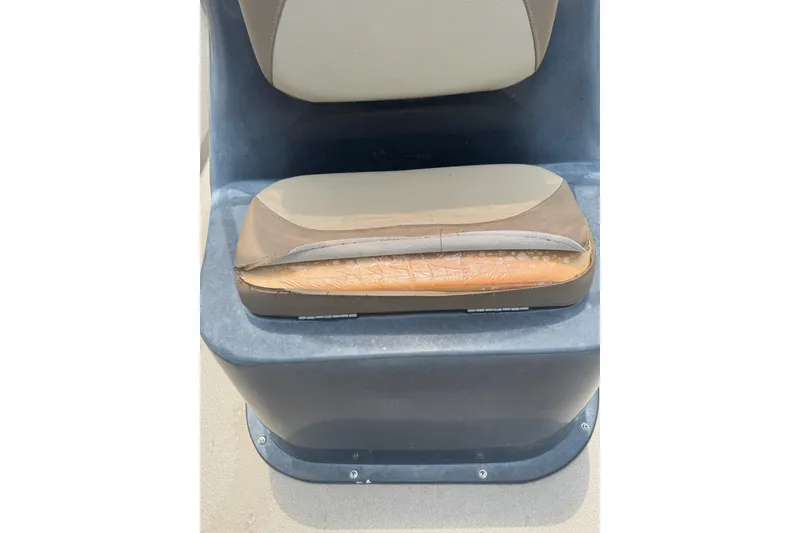 Slide: The Image of Worn seat cushion on 2020 Excel 203 Bay Pro boat, showing visible damage. - 15