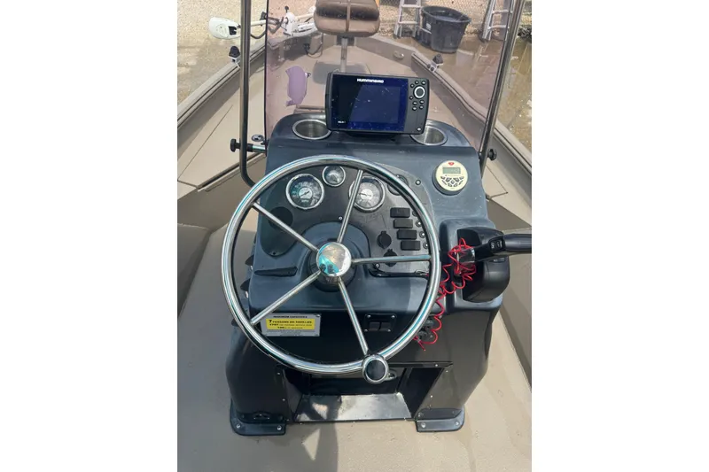 Slide: The Image of 2020 Excel 203 Bay Pro boat dashboard with steering wheel and navigation system. - 18