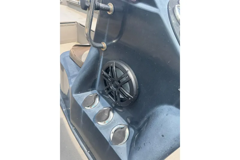 Slide: The Image of 2020 Excel 203 Bay Pro boat console with speaker and cup holders. - 21