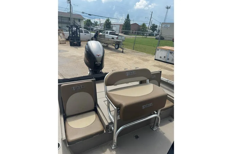 Slide: The Image of 2020 Excel 203 Bay Pro boat with seating and outboard motor in a parking area. - 22