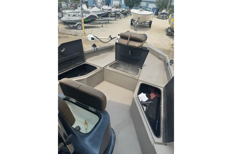 Slide: The Image of 2020 Excel 203 Bay Pro boat interior with open storage compartments. - 25