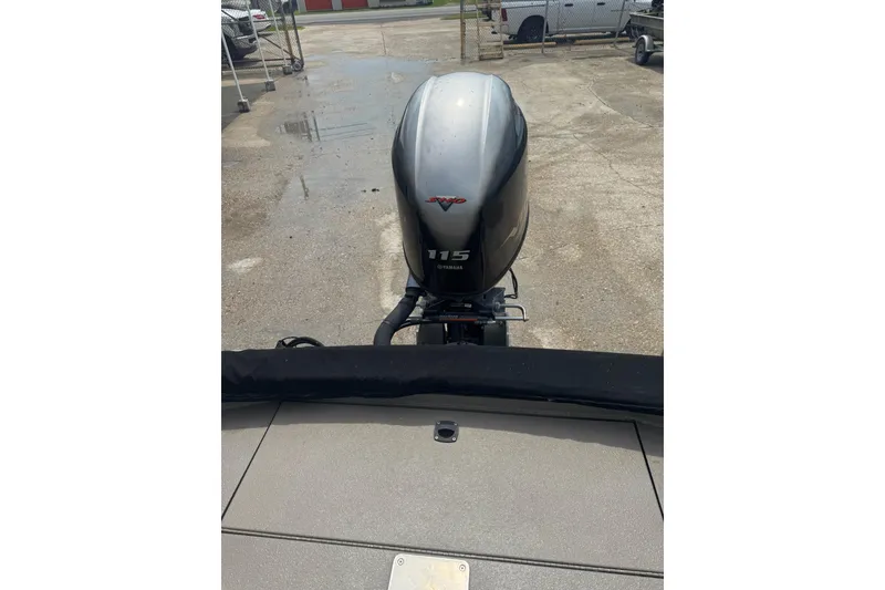 Slide: The Image of 2020 Excel 203 Bay Pro boat with Yamaha 115 outboard motor in a parking area. - 26