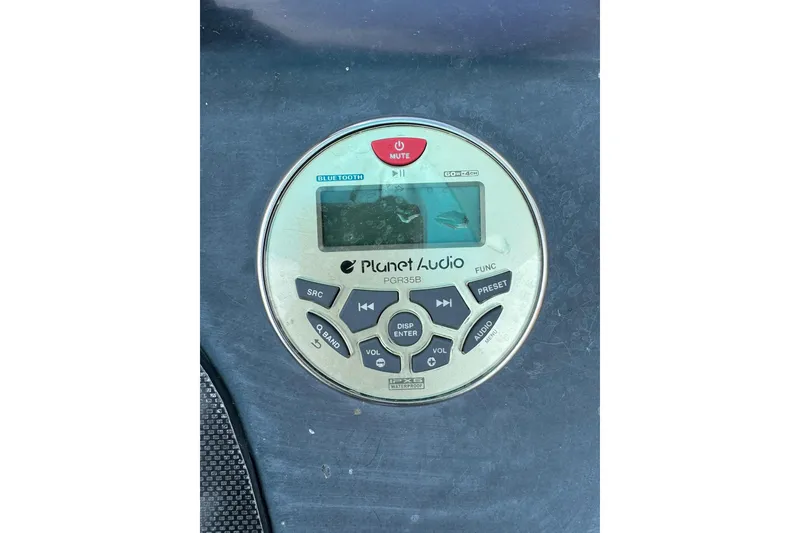 Slide: The Image of Close-up of a Planet Audio marine stereo system on a 2020 Excel 203 Bay Pro boat. - 27