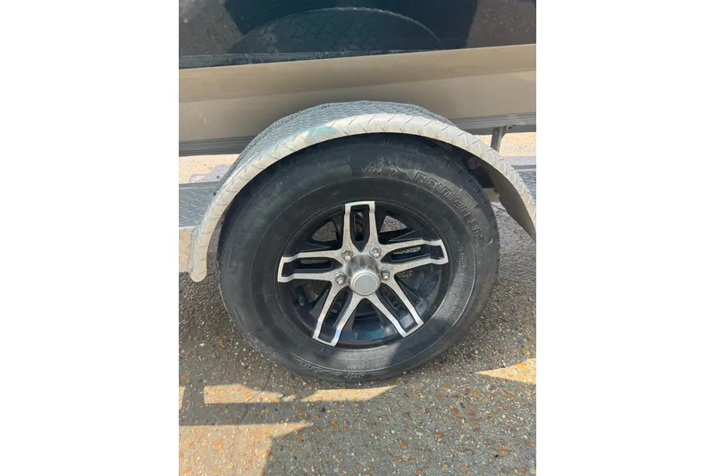 Slide: The Image of Trailer wheel of 2020 Excel 203 Bay Pro boat with black alloy rim. - 31